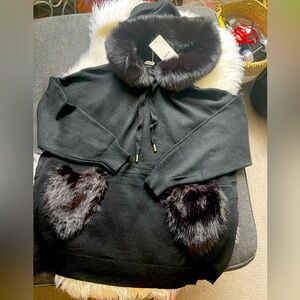 Black top with fuzzy heart shaped pockets and hoody.